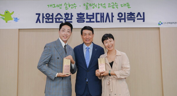 개그맨 손헌수(왼쪽)와 알맹상점 고금숙 대표(오른쪽)가 폐목재로 만든 홍보대사 위촉패를 들고 송병억 수도권매립지관리공사 사장(가운데)과 기념촬영을 하고 있다. 